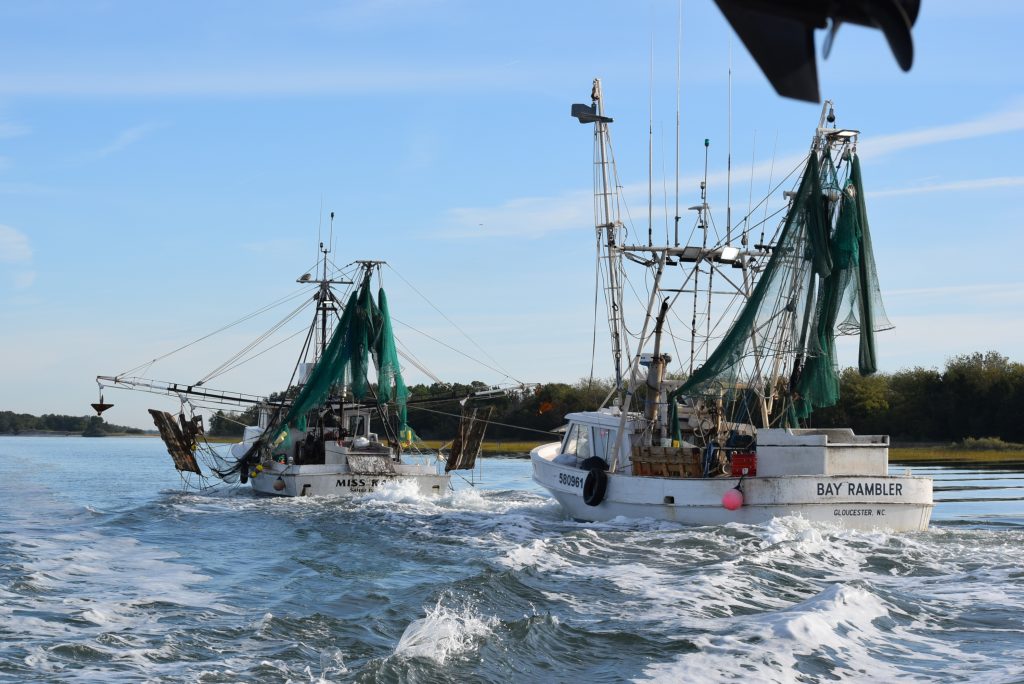 Shrimp boat towing anothr shrimp boat