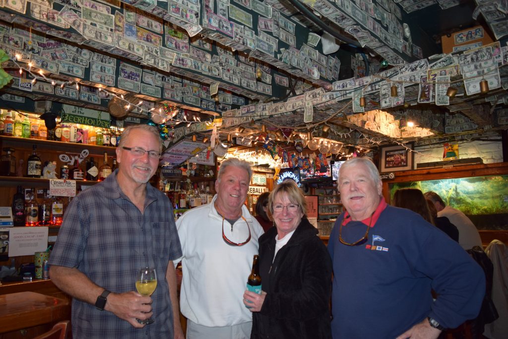 Michael, a lovely couple, and Bruce at Hemmingways. Notice the dollar bills on ceiling and walls